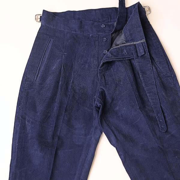 A “Gurkha” pant Trosuer with pleats, double side strap buckle, slanted front welted pocket & back patch pocket.