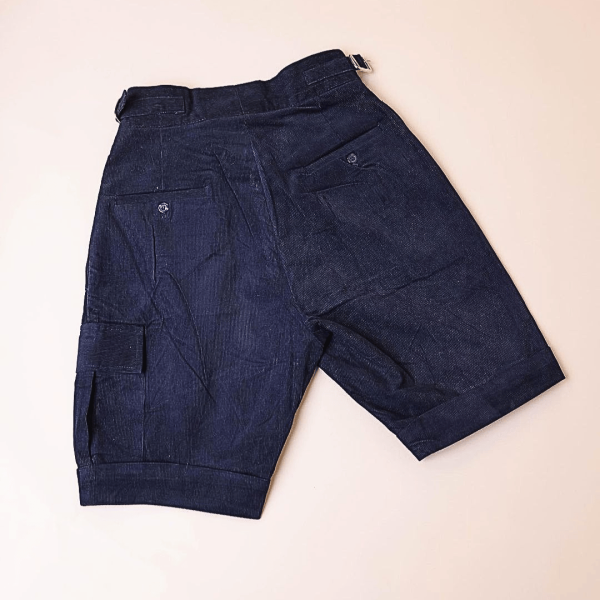A “Gurkha”pant shorts with pleats, double side strap buckle, combat patch pocket.