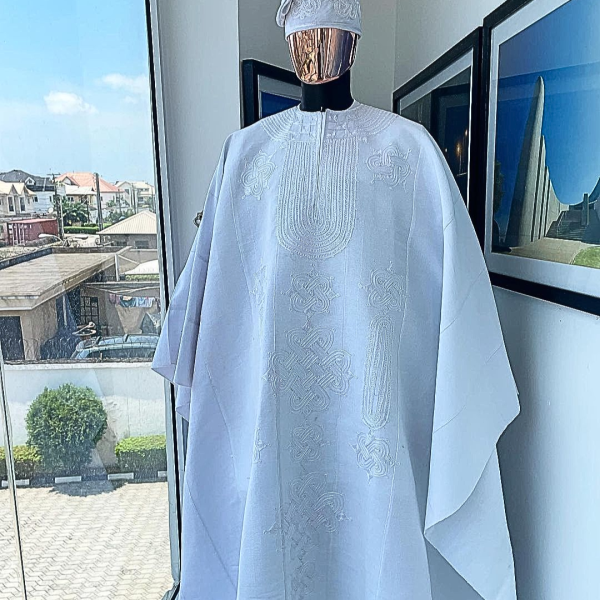 A Royal monochrome cocaine white agbada, dashiki, sokoto & fila floral embrodery aso oke design African traditional agbada.