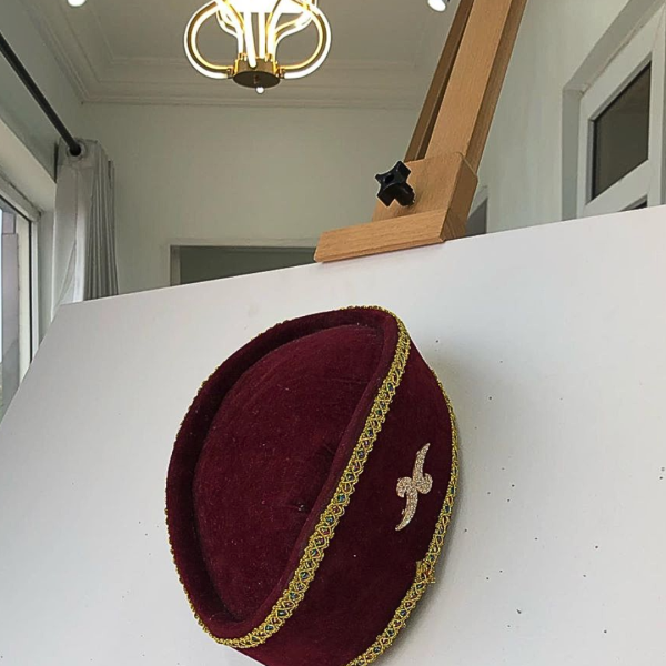 A Burgundy and Gold Ceremonial African Traditional Hat