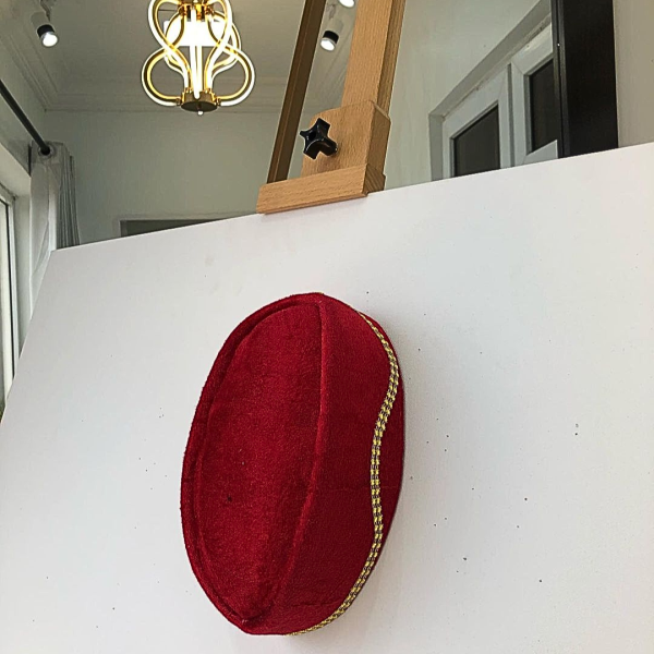 A Red and gold lines ceremonial African Traditional hat